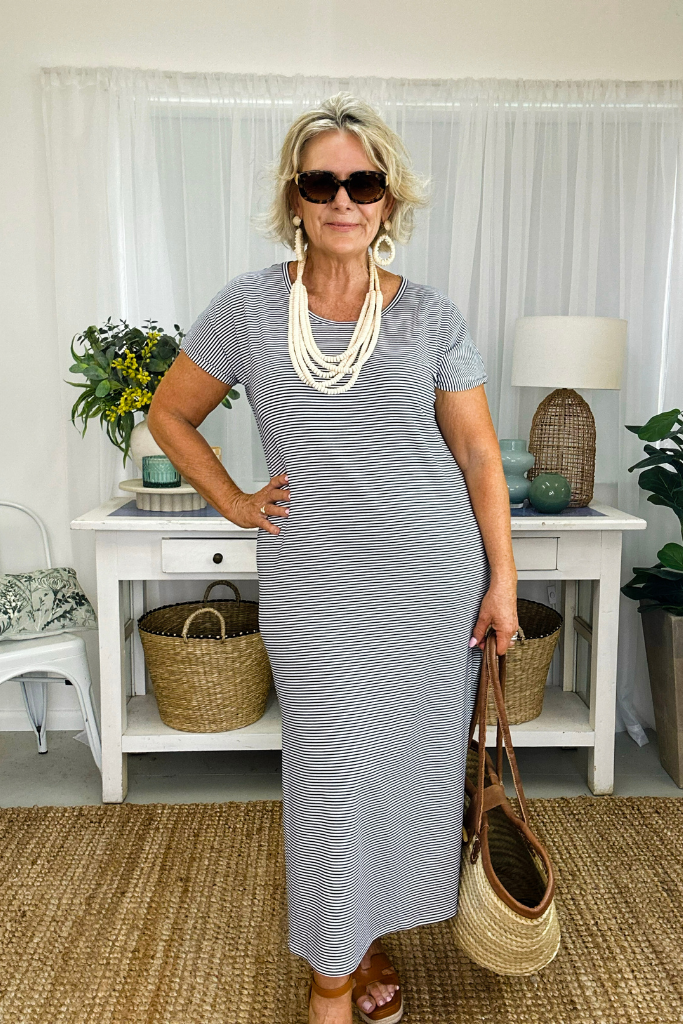 Navy and white thin stripe bamboo maxi dress styled with oversized sunglasses and sandals
