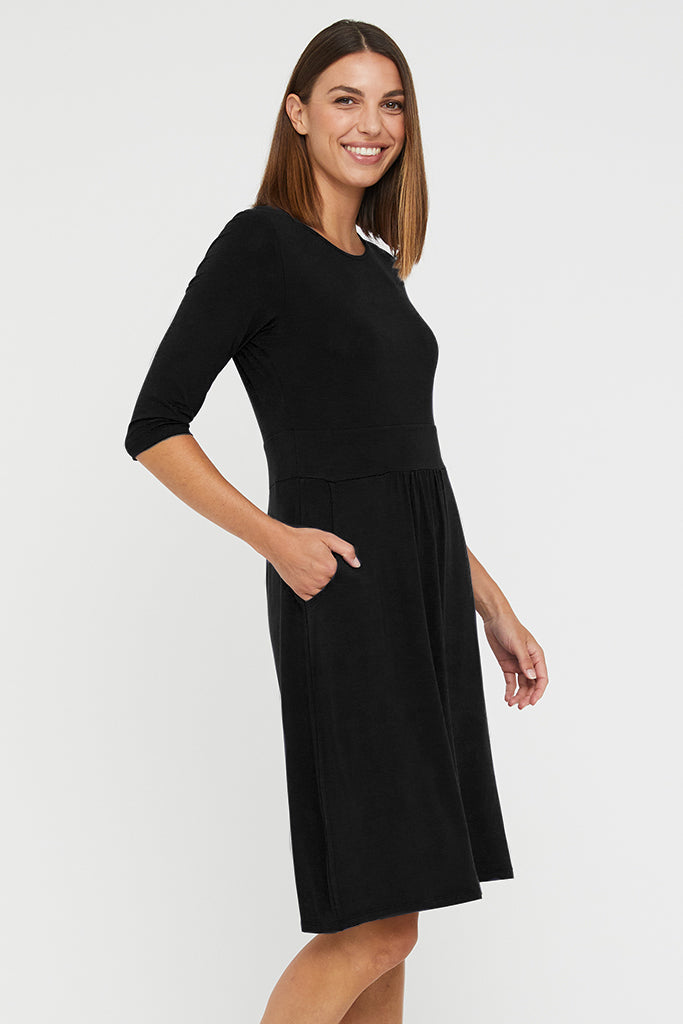 Side view of black bamboo dress with side pockets and 3/4 length sleeves