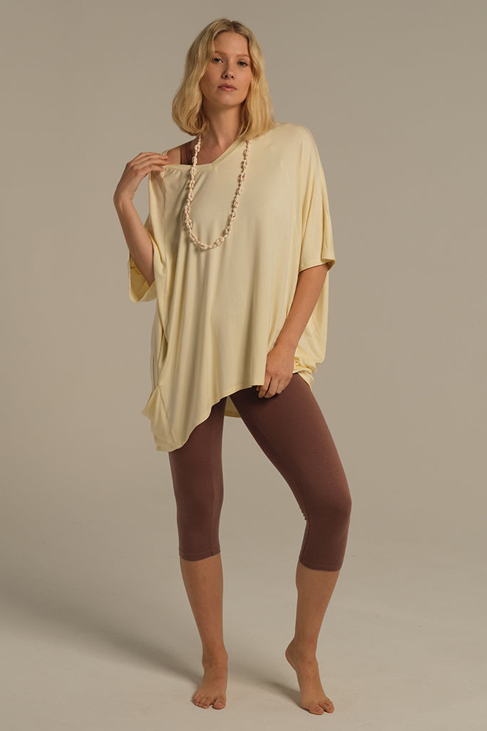 a model wearing mousse 3/4 leggings paired with an oversized light yellow top