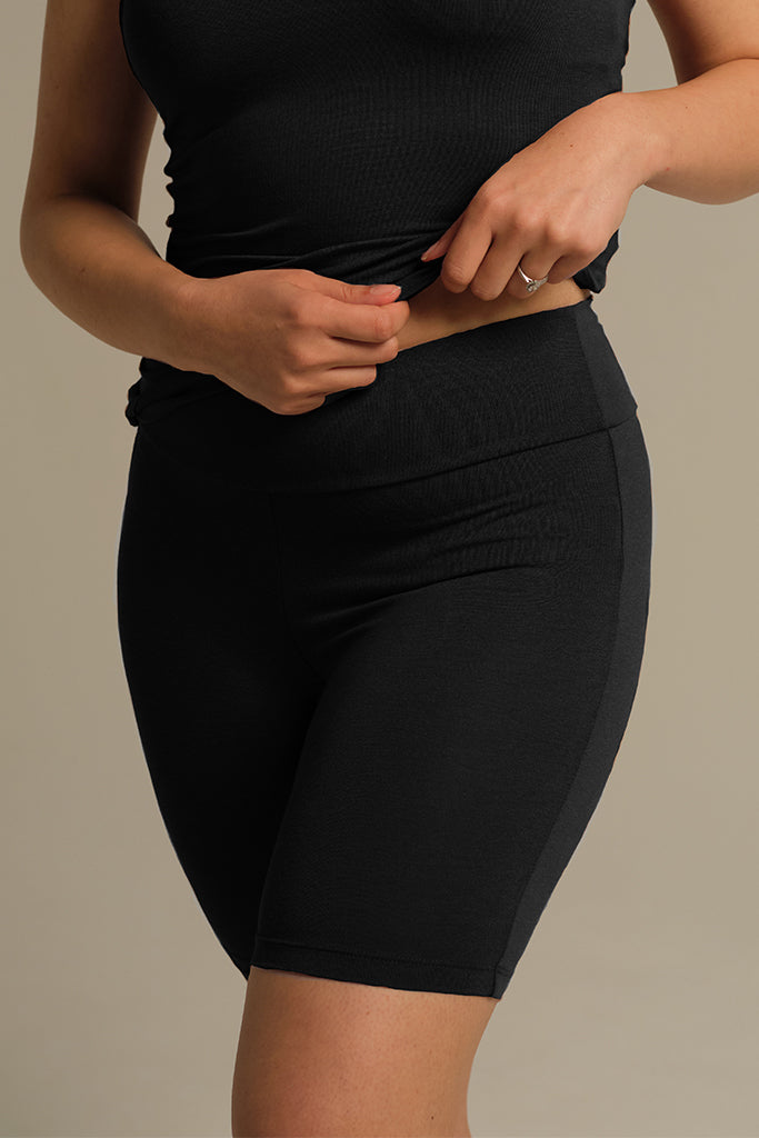 Person wearing black bamboo biker shorts