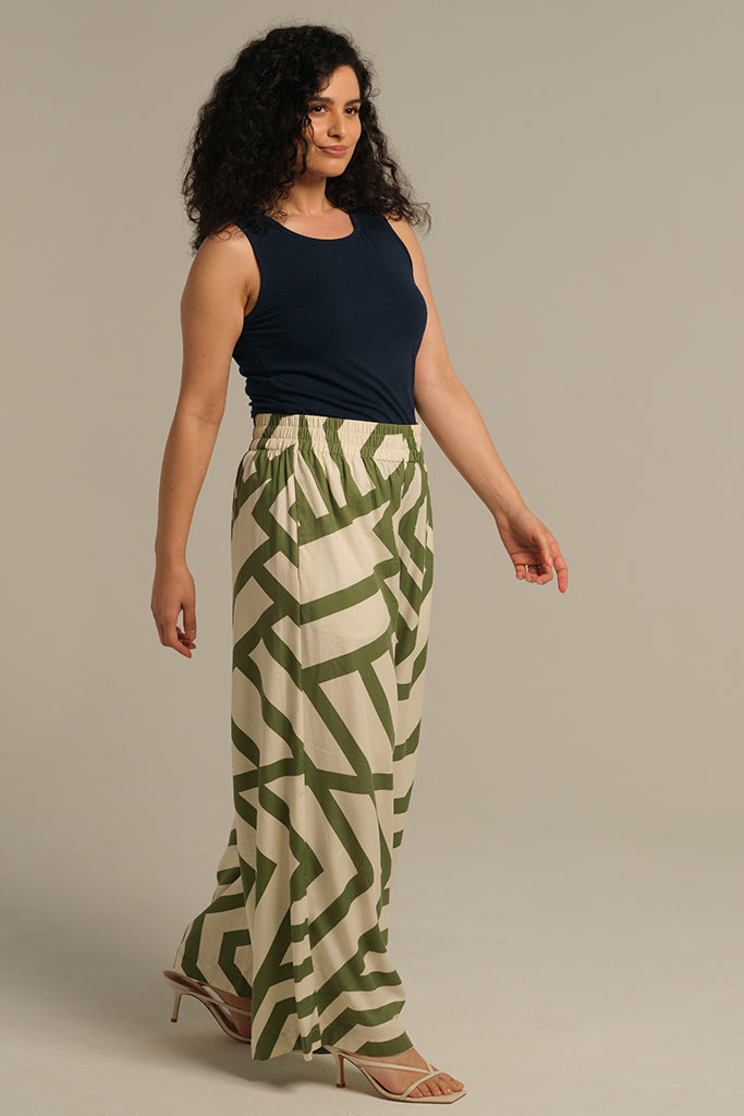 Model in motion wearing a deep blue fitted tank top. Super soft cotton blend with wide shoulder straps