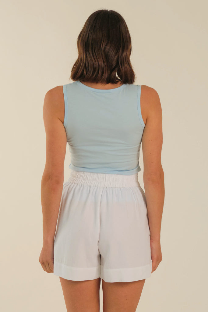 Back view of a powder blue singlet with high neckline and wide straps
