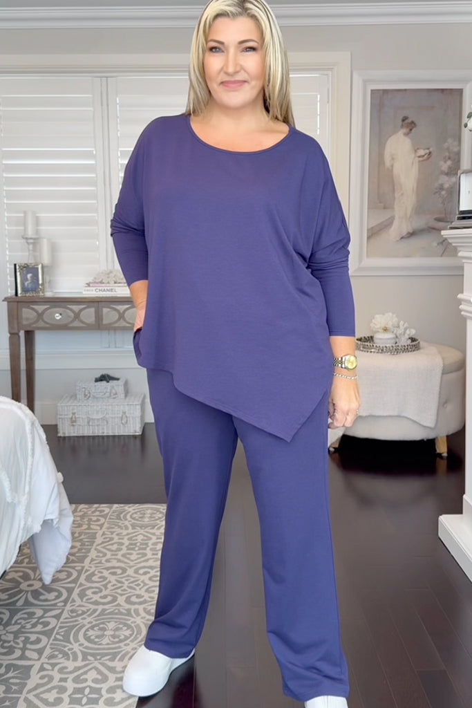 indigo blue travel outfit consisting of the asymmetric hem top and long straight pants