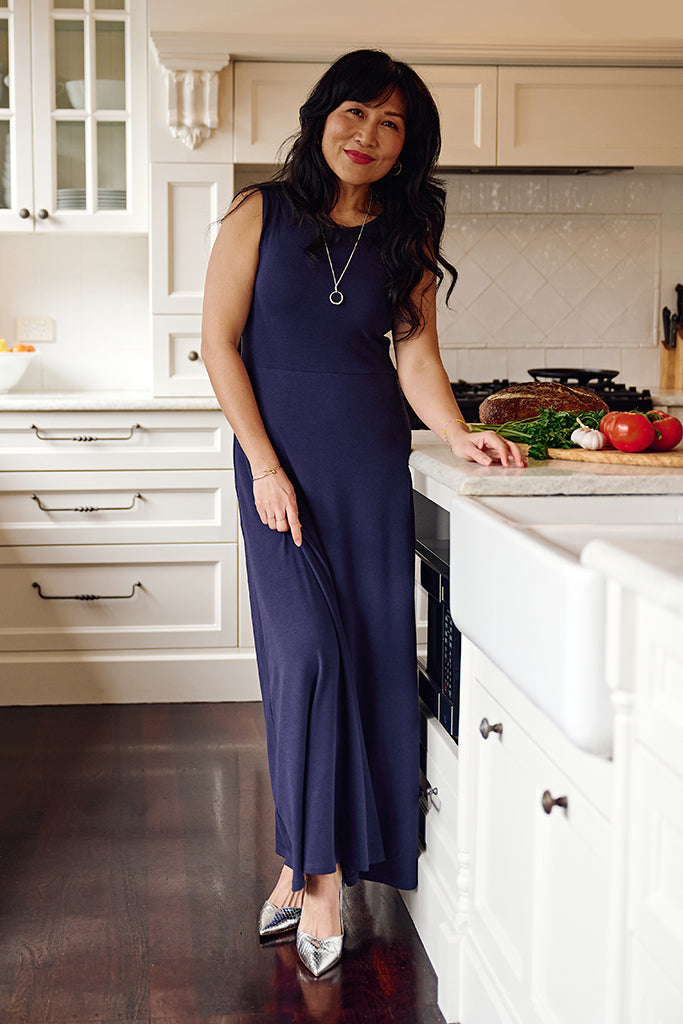 Simple indigo sleeveless dress with streamlined fit through the bust and relaxed full-length hem.