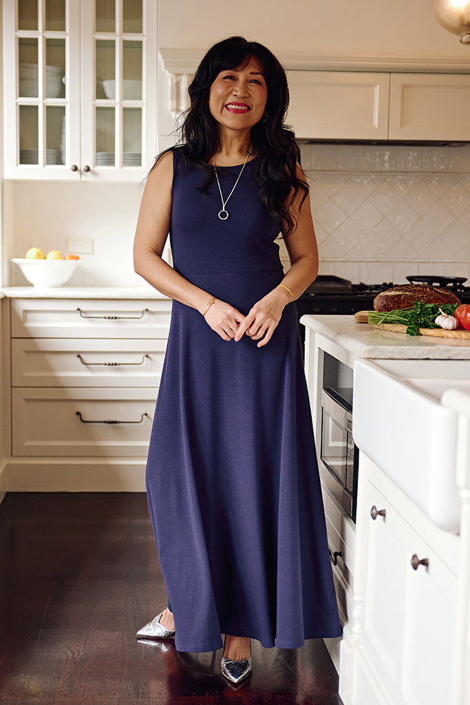 Indigo sleeveless maxi dress with fitted top and flowy skirt.