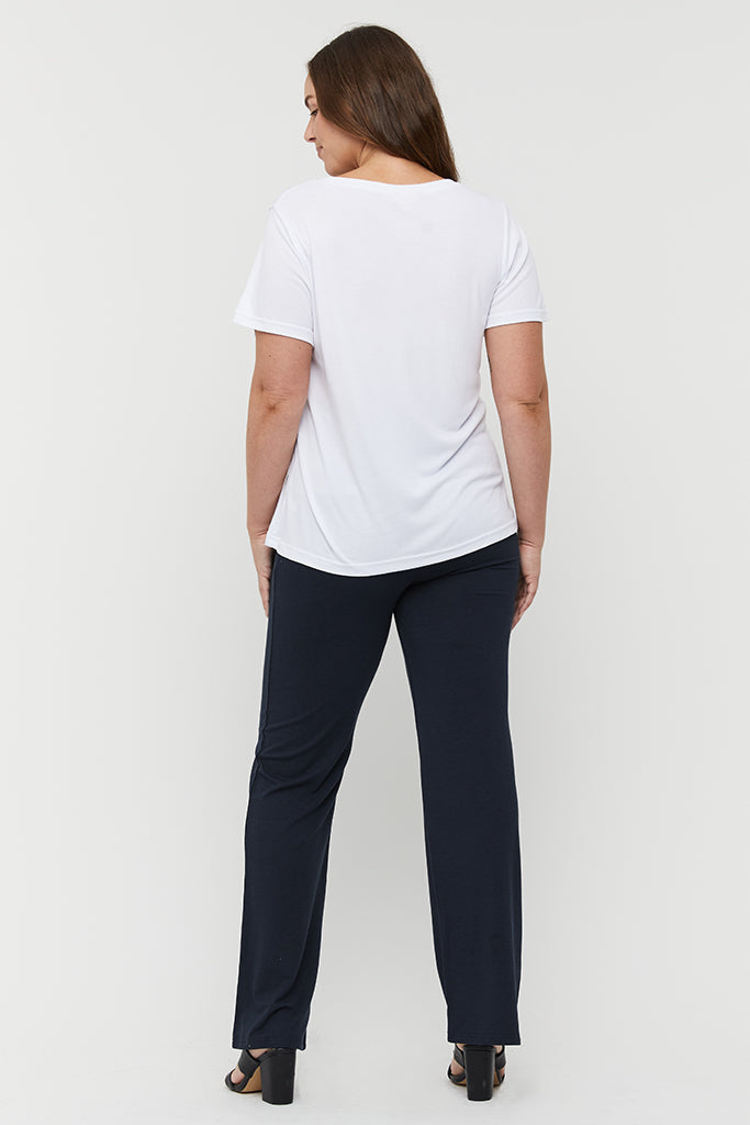 Straight-leg bamboo pants in navy styled with heels and a tee.