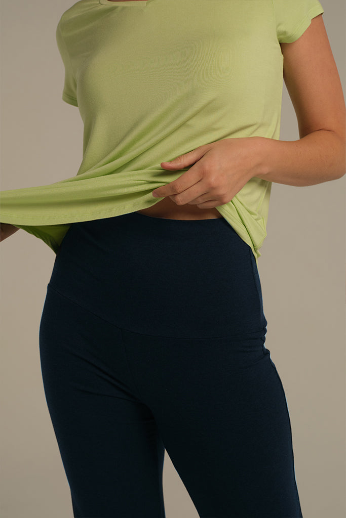 Close-up of dark navy pants showing soft bamboo fold-over waistband