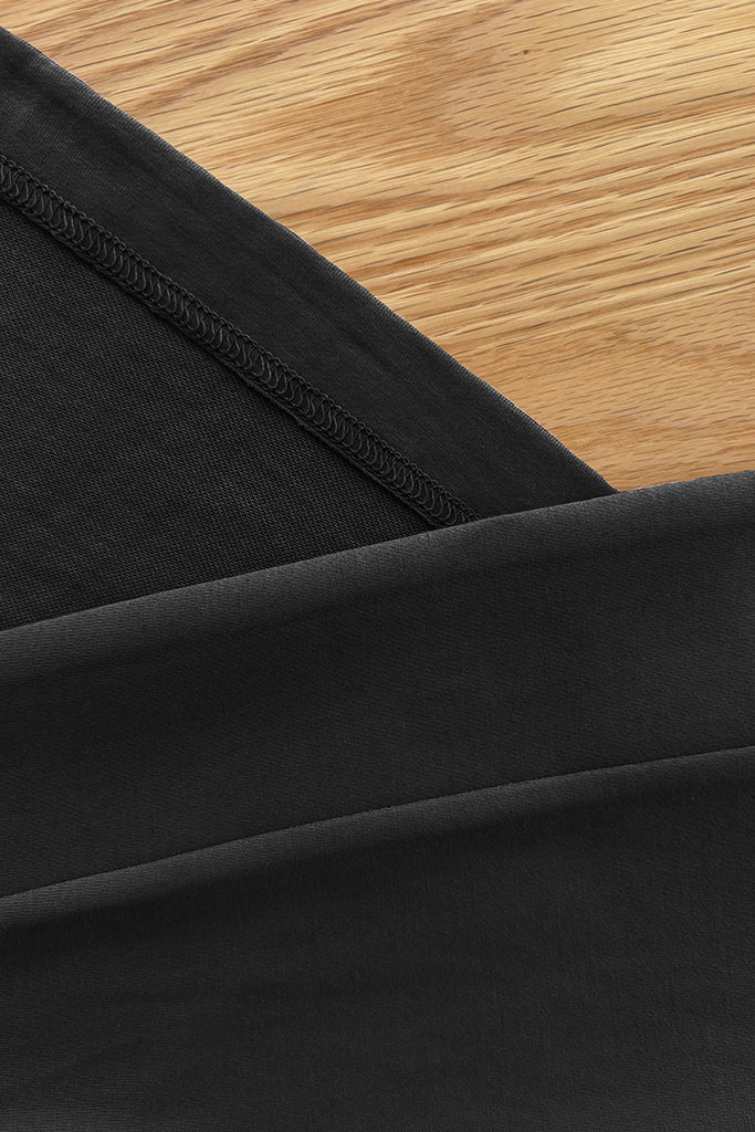 Close-up of black bamboo fabric on a wooden surface