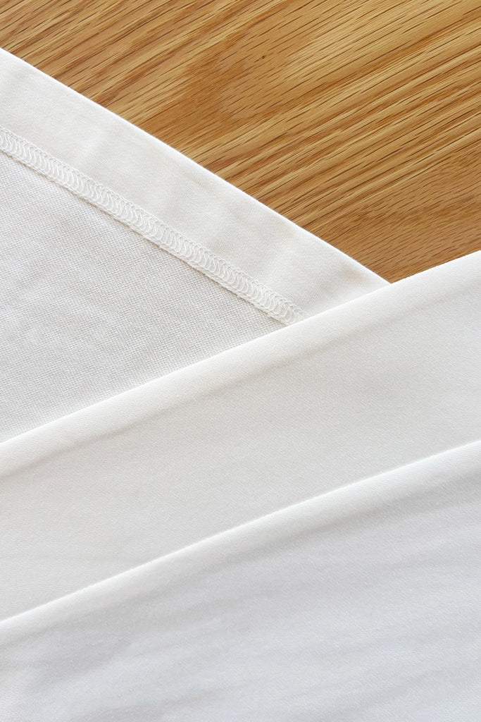Close up of white bamboo fabric on a wooden surface
