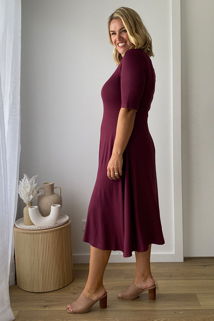 Side view of lightweight midi dress in burgundy.