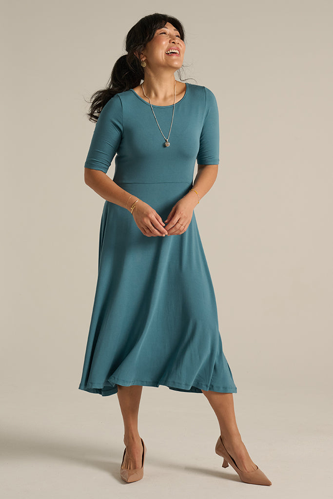 Front view of blue bamboo dress, featuring a soft waistband and above elbow sleeves.