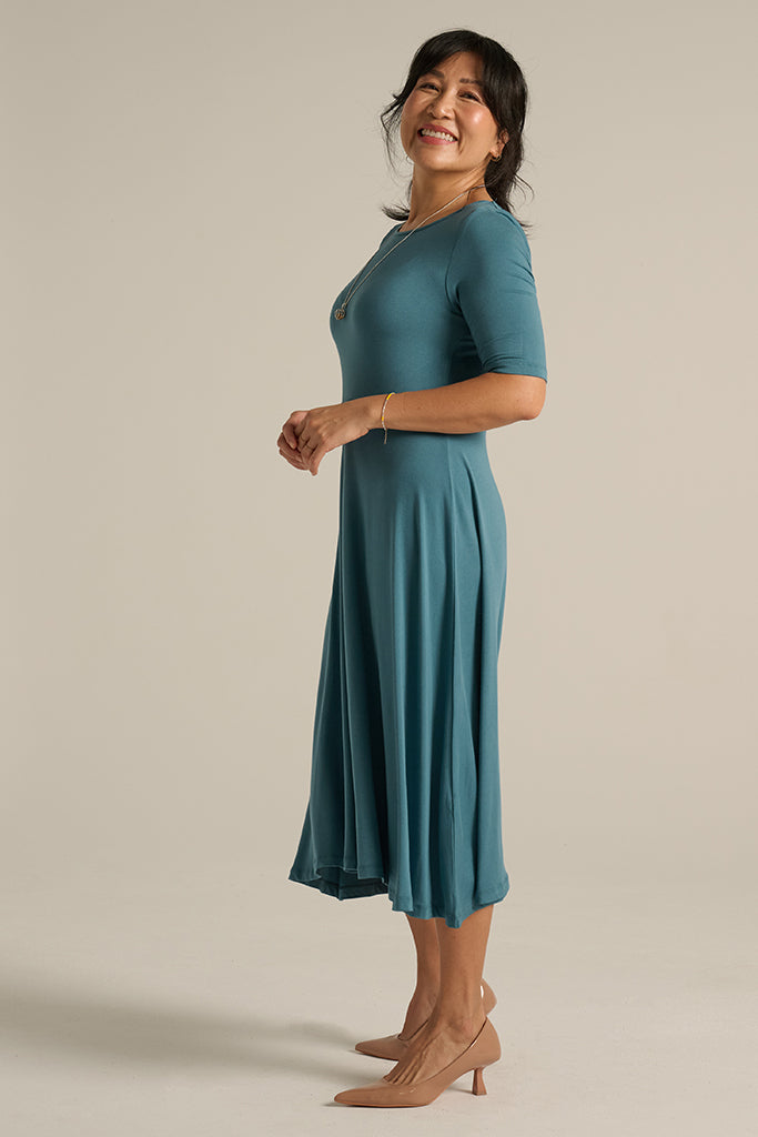 Side view of ocean blue midi dress.