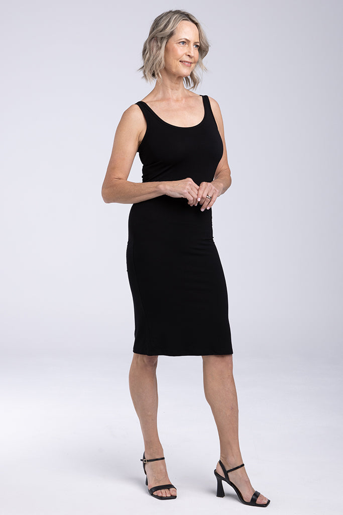 Model wearing a tight sleeveless dress made out of comfortable and breathable bamboo.