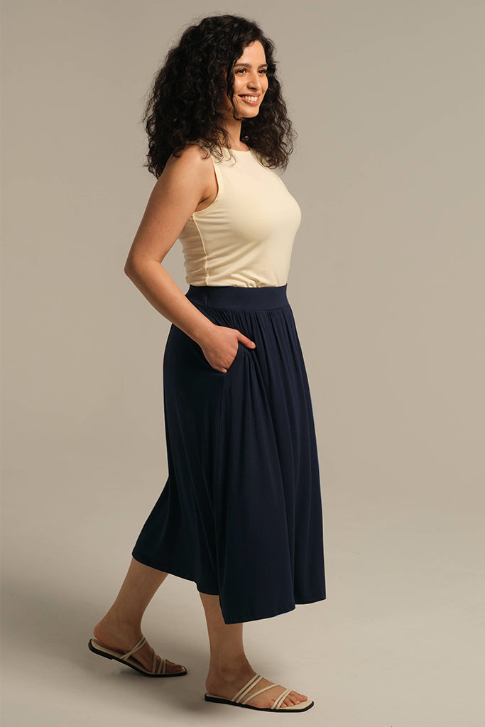 Side view of navy midi skirt showing side pockets