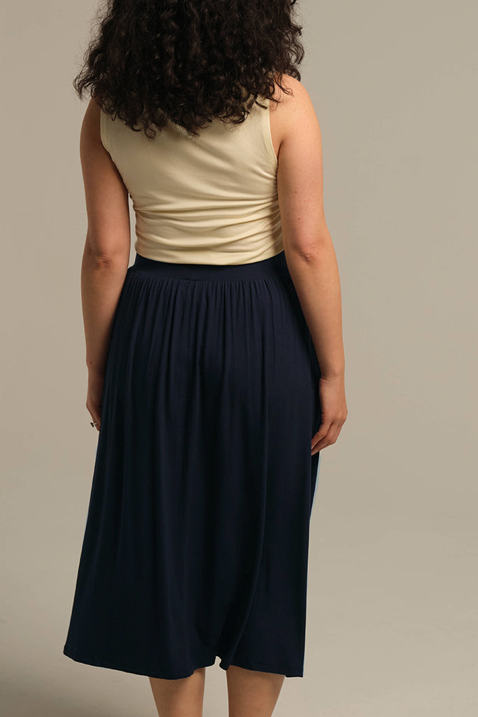 Back view of dark navy bamboo midi skirt with elastic waistband