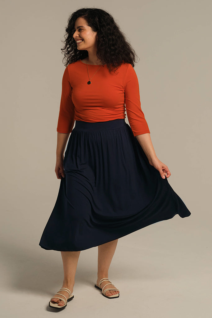 Navy midi skirt in motion with 3/4 sleeve top