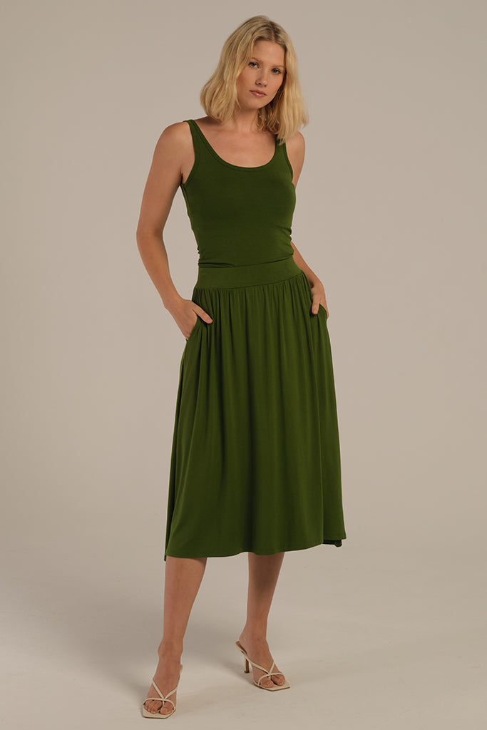 midi skirt in green with side pockets and elastic waistband styled with green tank top