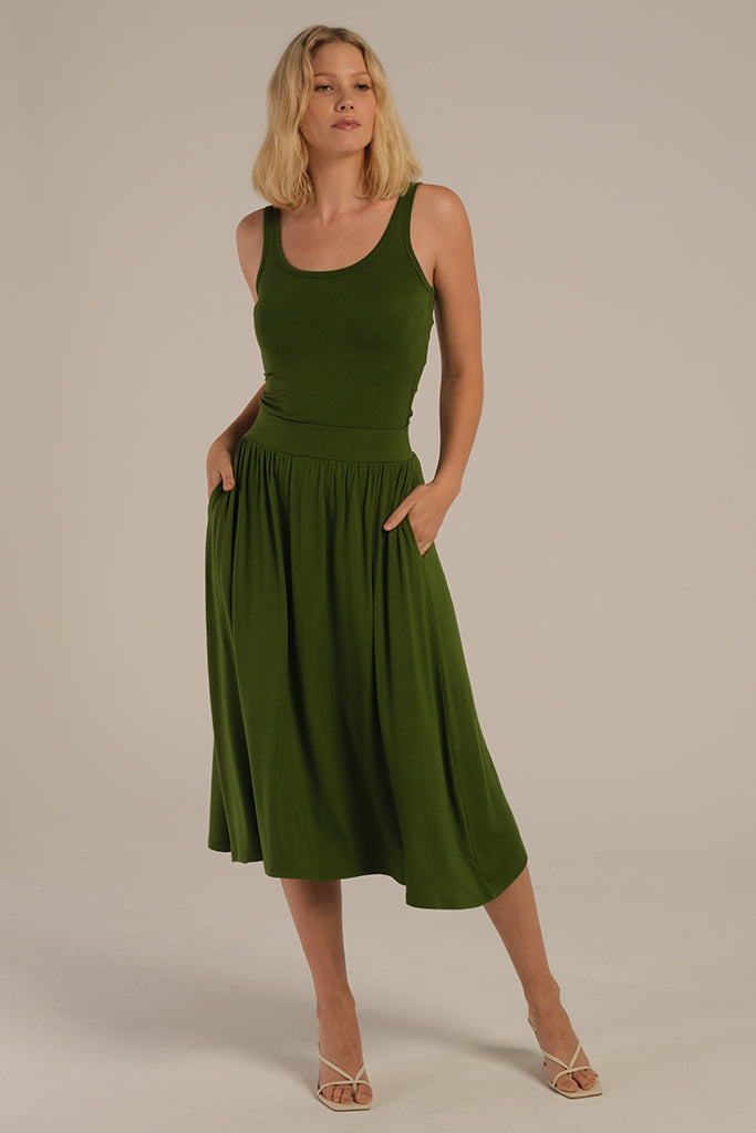pleated green skirt with pockets styled with the matching green tank top