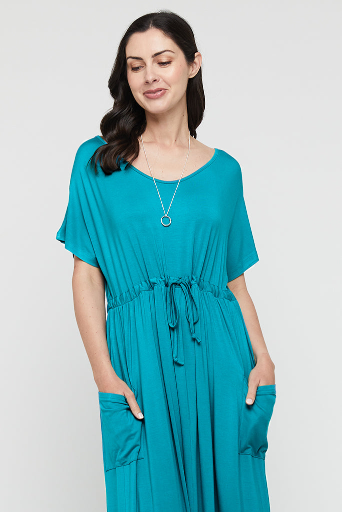 Close up of teal bamboo maxi dress, featuring side pockets and adjustable drawstring.