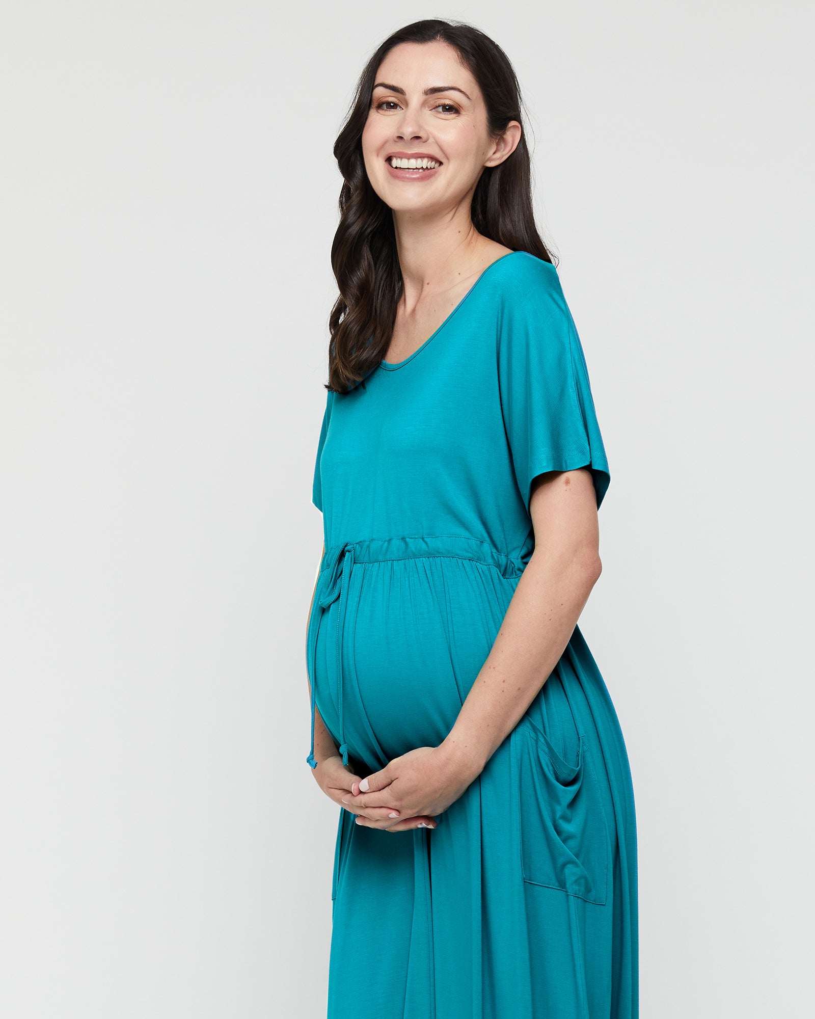 Close up of the bamboo maternity dress in teal blue.