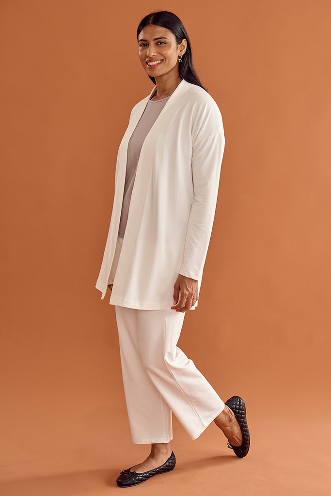 Model wearing a soft white cardigan and matching pant.