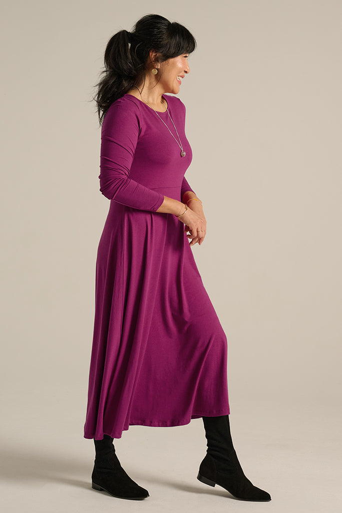Bamboo midi dress flowing gently as model moves, capturing the breathable and lightweight fabric.