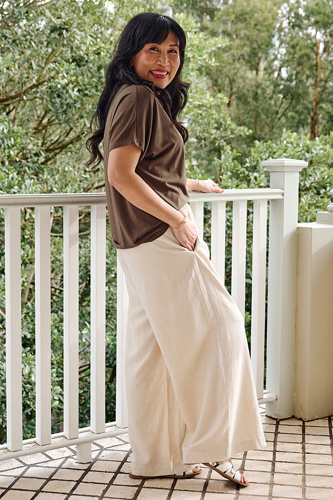 Side view of model wearing a bamboo-linen tee paired with wide-leg pants.