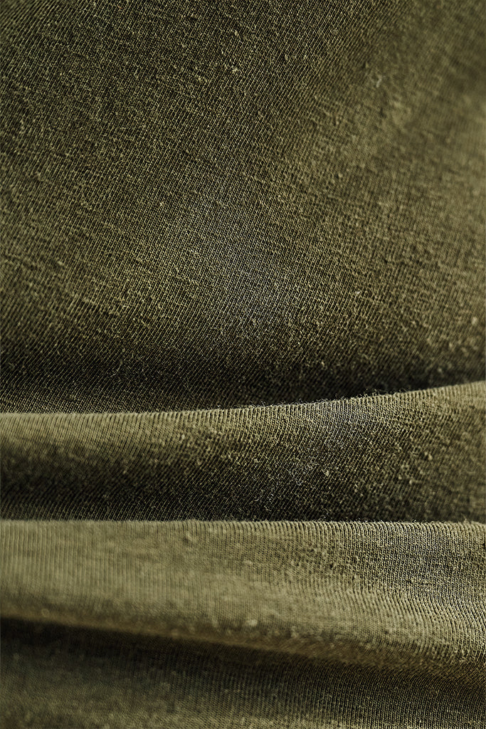 Close-up of green bamboo-linen fabric with visible texture