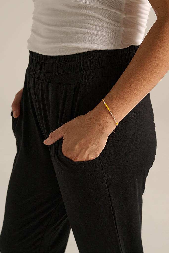 a close up view of the pockets and a soft elasticated waistband on the peggy bamboo trousers