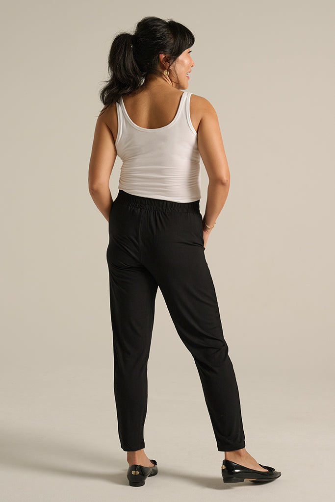 a back view of the tapered bamboo trousers with an elasticated waistband in black