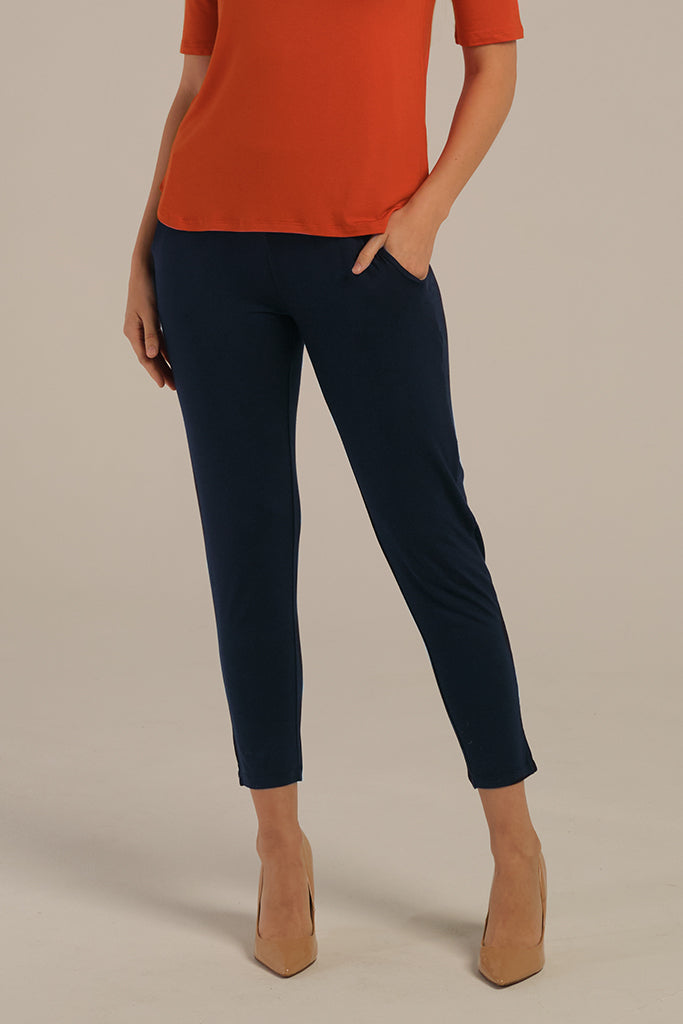 a close up look of the peggy bamboo pants in dark navy with side pockets and a tapered leg