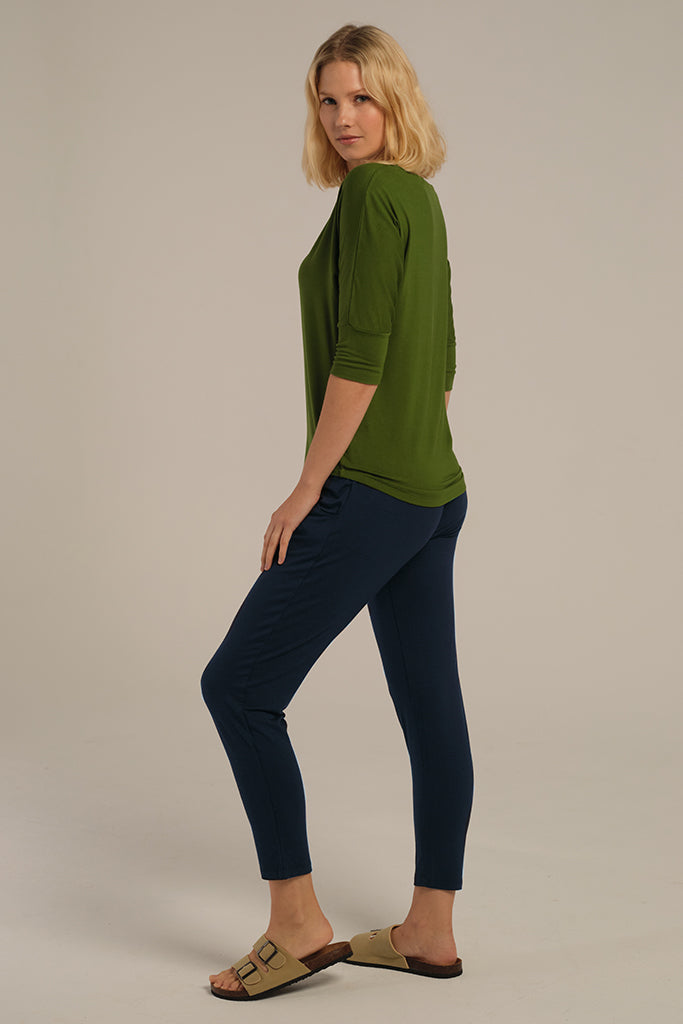 a side view of the bamboo peggy pants in dark navy featuring a tapered leg and side pockets