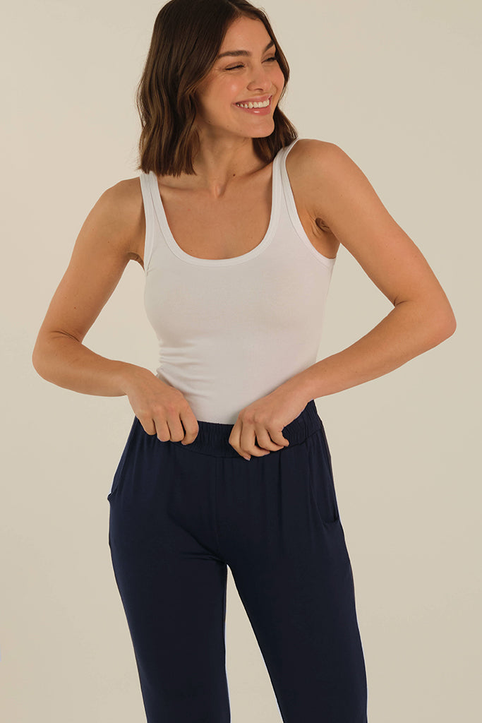 a close up look of the peggy pants with the soft elastic band and side pockets in dark navy