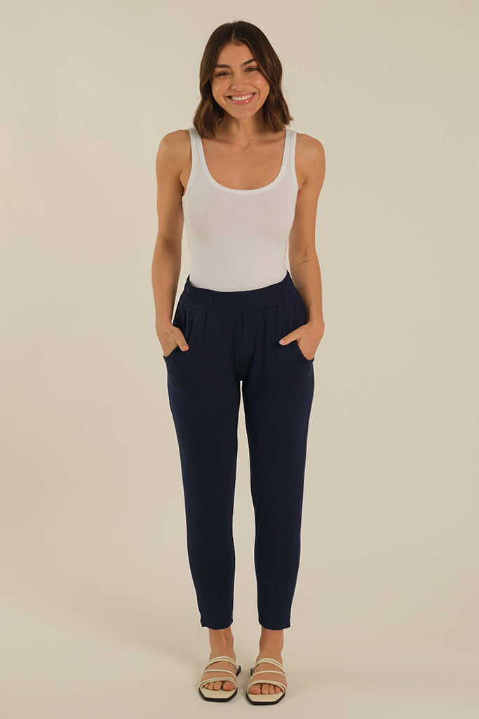 a woman wearing bamboo trousers with side pockets, elastic waistband and a tapered leg