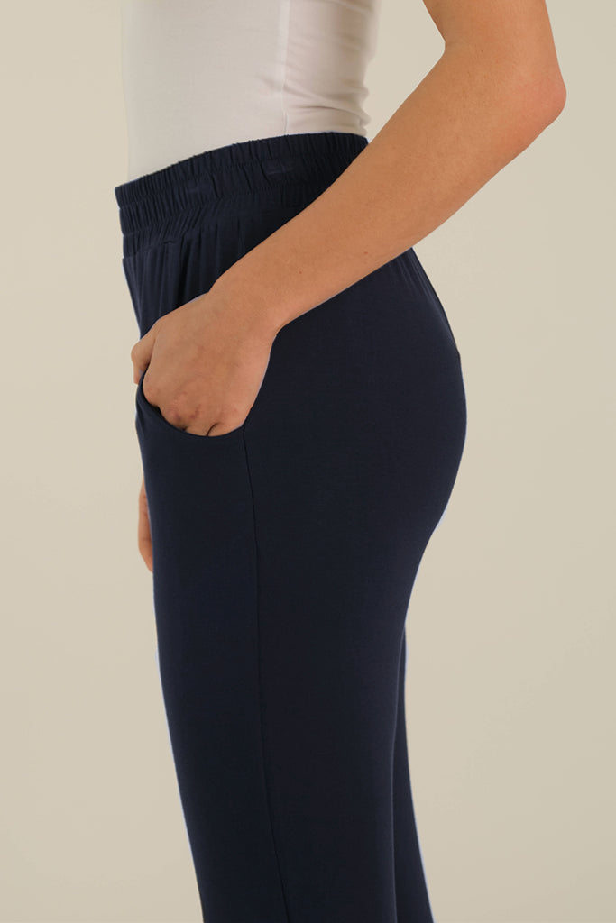 a detailed view of the peggy bamboo pants with side pockets and an elasticated waistband in dark navy colouway