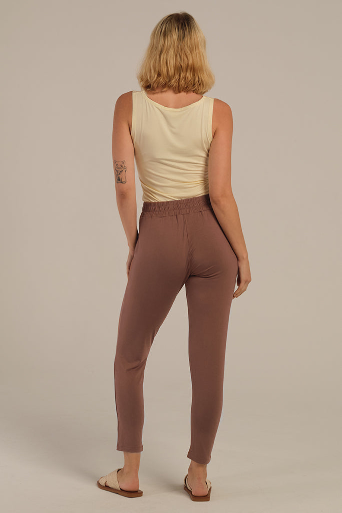 a back view of the peggy pants in mousse, with a comfy elastic waistband