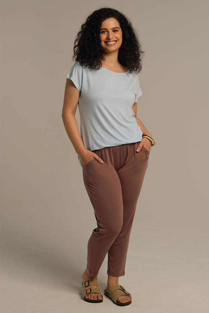 a model wearing the peggy bamboo pants with side pockets and a stretchy waistband