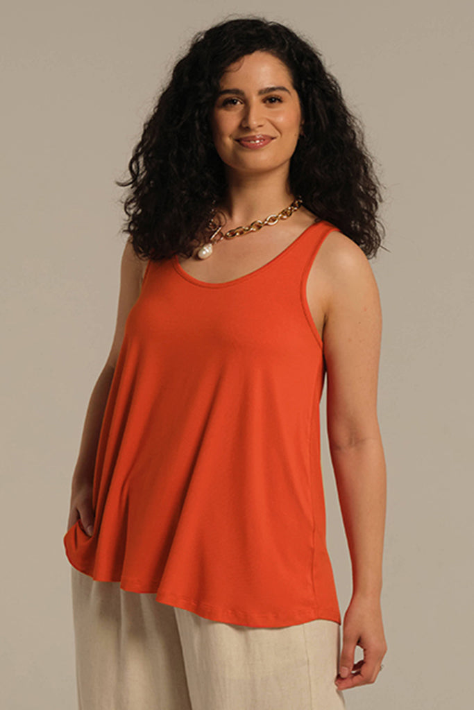 Model wearing floaty bright orange singlet perfect for summer.