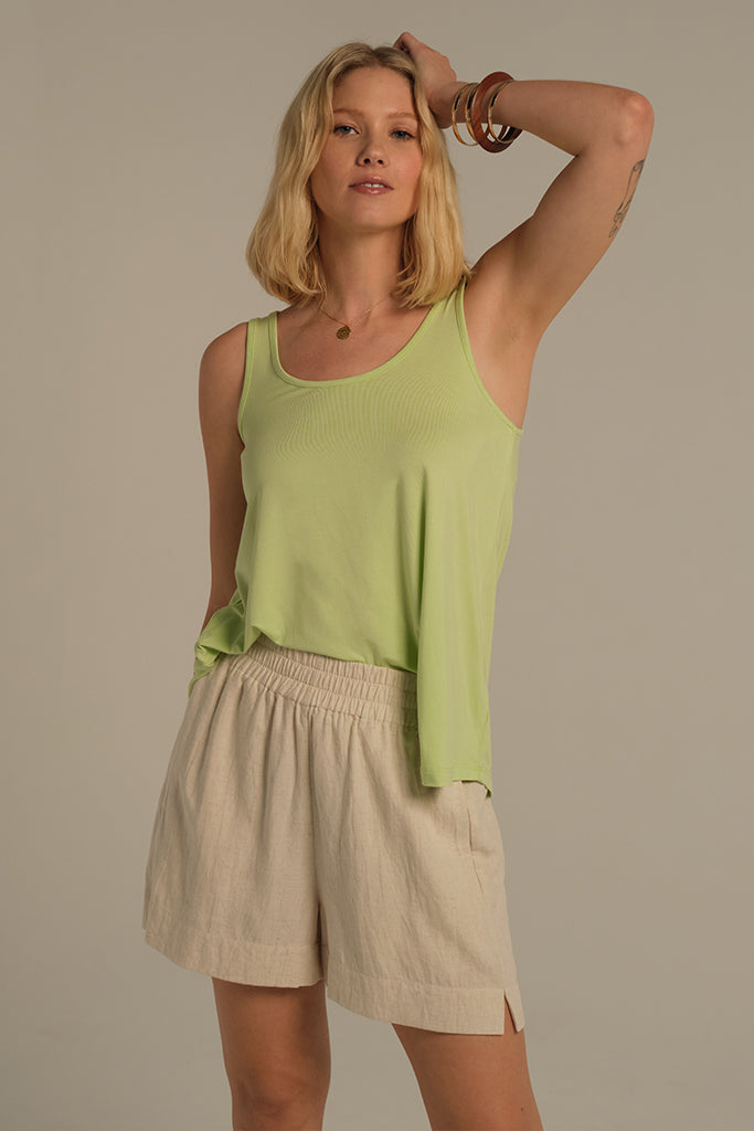 Model wearing light green breathable bamboo singlet perfect for hot summer days.