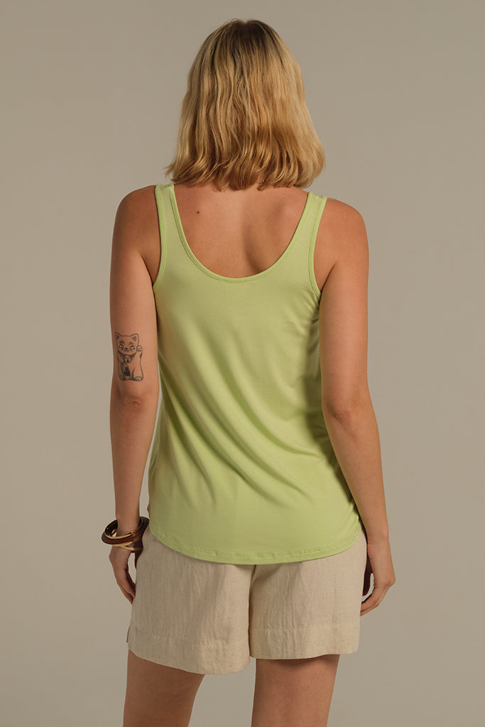 Back view of model wearing a-line lettuce green singlet with round neckline.