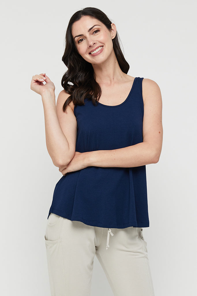 Model wearing navy a-line shaped bamboo singlet with scoop neck