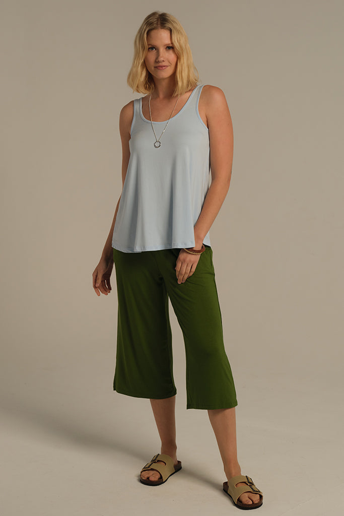 Model wearing light blue a-line breathable bamboo singlet perfect for hot summer days.