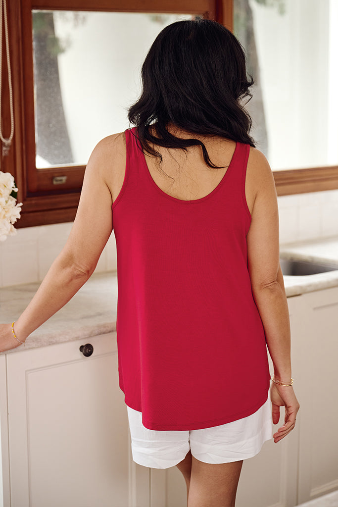 Back view of model wearing a red bamboo singlet with a scooped back.