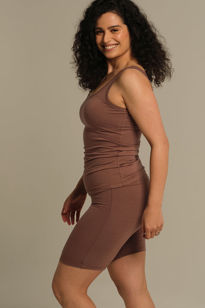 Women in motion wearing brown fitted singlet.