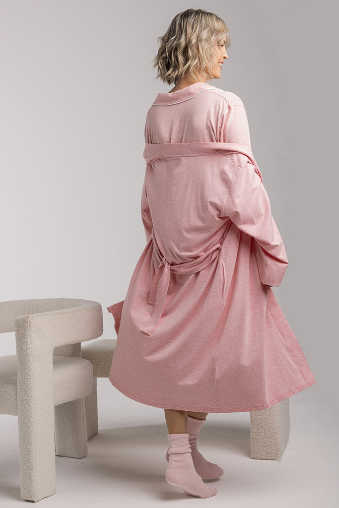 Back view of model wearing a pink bamboo dressing gown and pink pyjamas