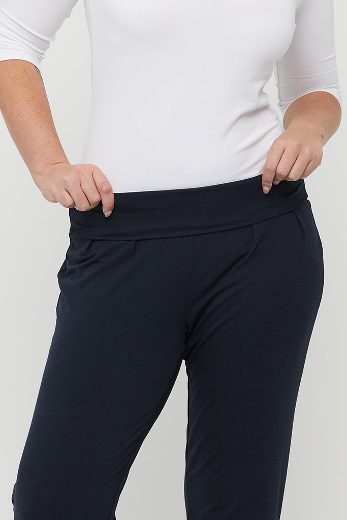 a close up view of the bamboo slouch pants in dark navy with a folded waistband