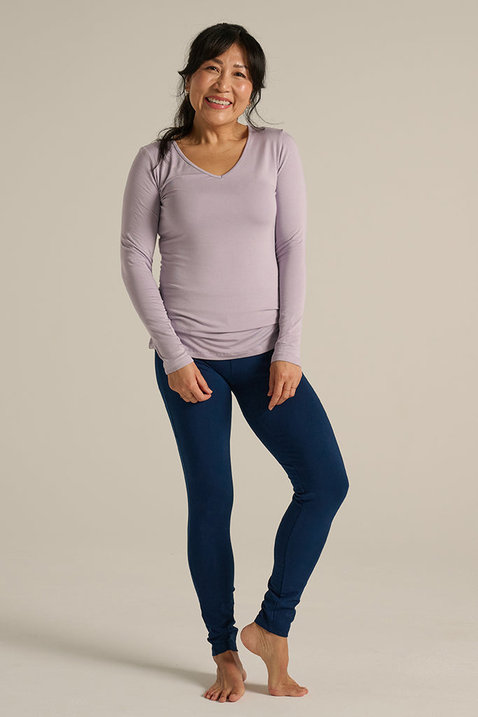 a petite woman wearing full length soft bamboo leggings in navy