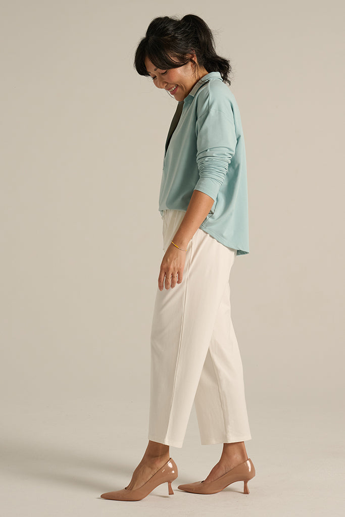 side view of the travel pants with side pockets in soft white