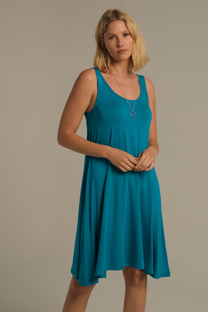 Woman wearing a teal sleeveless summer dress