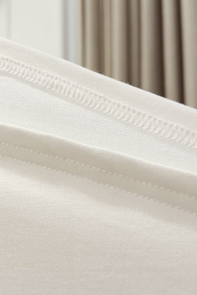 Close-up of soft white bamboo french terry fabric with a blurred background